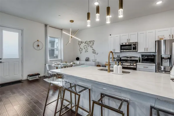 a kitchen with stainless steel appliances a microwave a stove and refrigerator