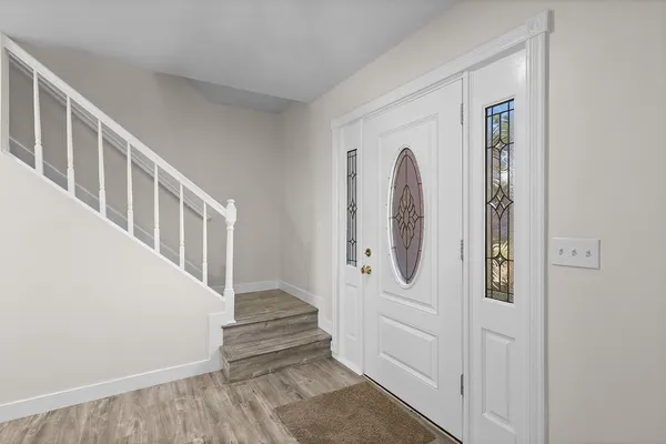 a view of an entryway with wooden floor