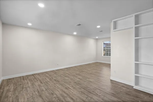 wooden floor in an empty room with a window