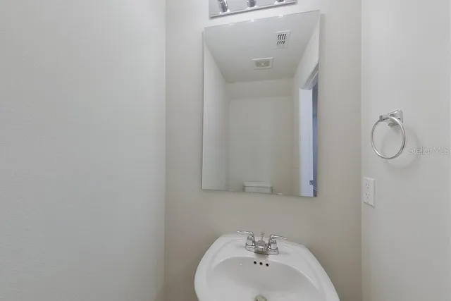 a bathroom with a sink and mirror