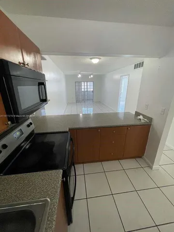 a kitchen with stainless steel appliances a stove a sink and a refrigerator