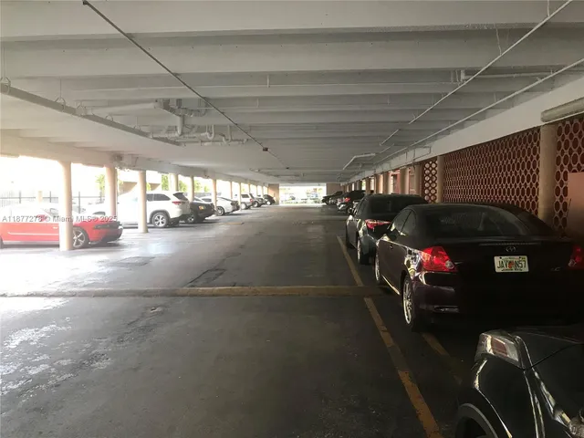 a view of parking garage with cars