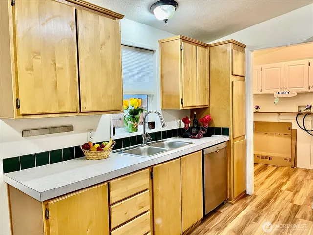 a kitchen with a sink and a refrigerator