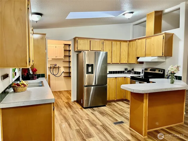 a kitchen with a sink appliances and cabinets