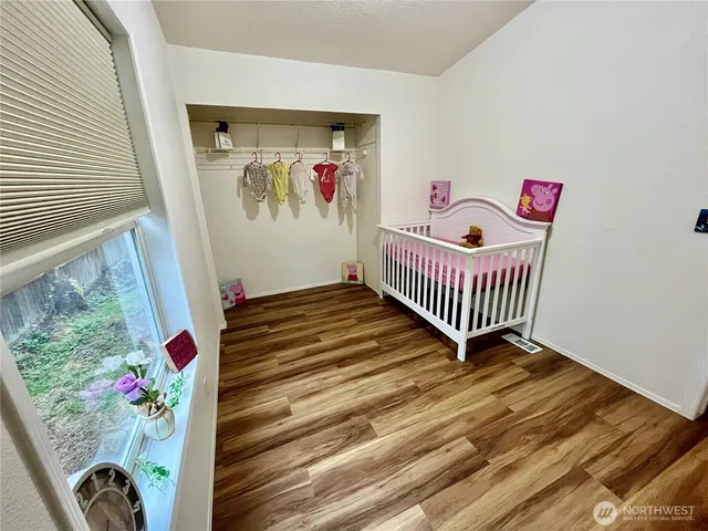 a bedroom with baby crib and toys