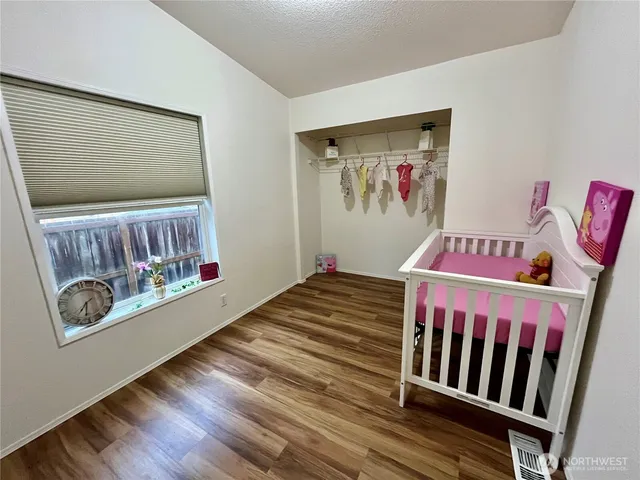 a bedroom with furniture and baby crib