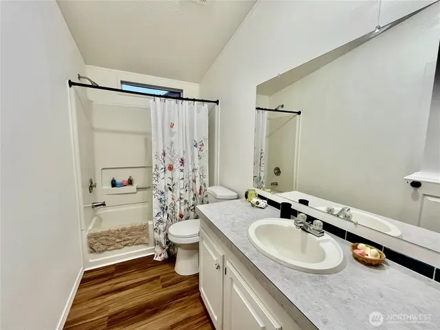 a bathroom with a sink double vanity and a shower