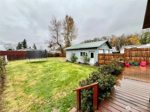a view of a house with backyard and sitting area