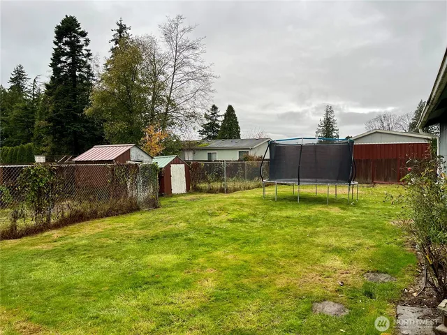 a view of a house with a yard and sitting area