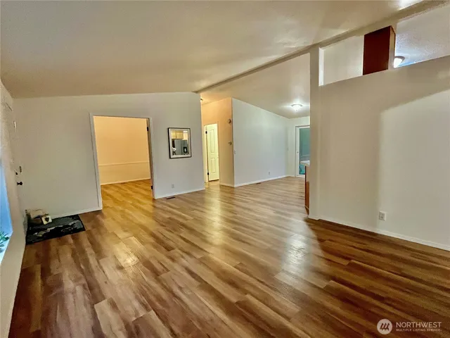 a view of a room with wooden floor