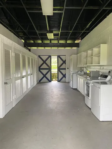 a large white kitchen with a large window