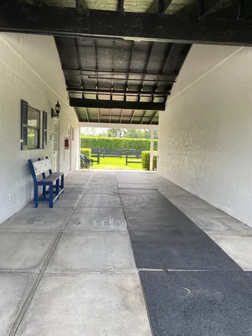 a view of a patio with table and chairs and a barbeque