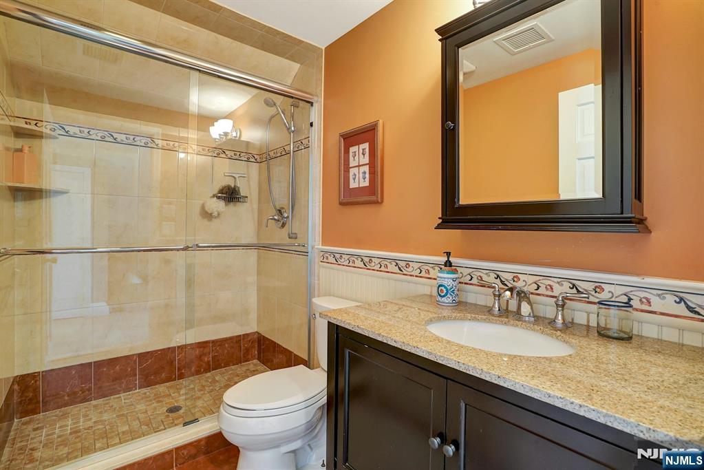 599 Point Avenue Brick, NJ 08724 - Photo 23 of 48 a bathroom with a granite countertop sink toilet and shower