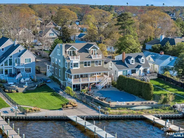 an aerial view of a house with a garden and lake view