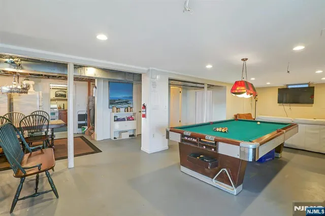 a room with chairs and pool table