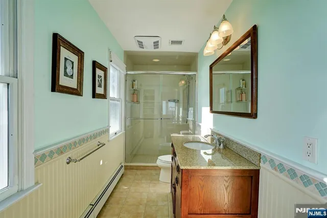 a bathroom with a sink mirror and toilet