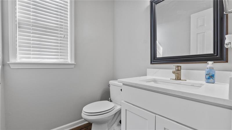 3525 Elder Field Lane Cumming, GA 30040 - Photo 13 of 45 a bathroom with a sink a toilet and a mirror