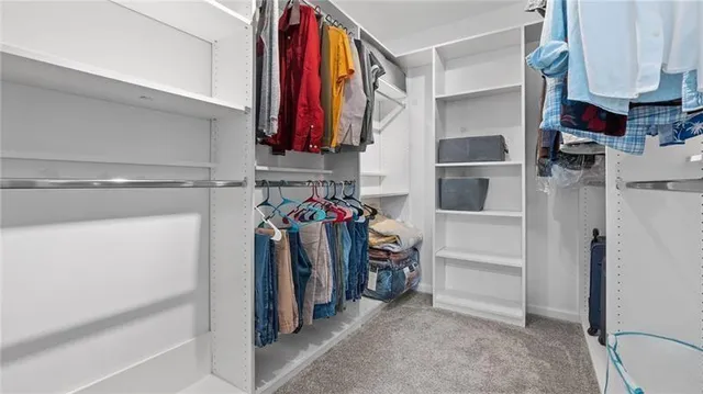 a spacious bathroom with a double vanity sink a mirror and shower