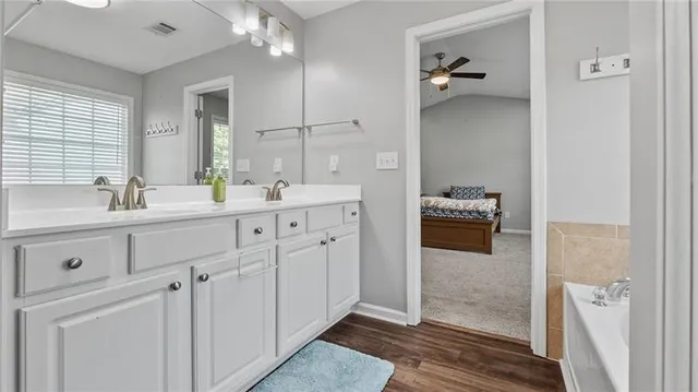 a bathroom with a double vanity sink toilet and shower