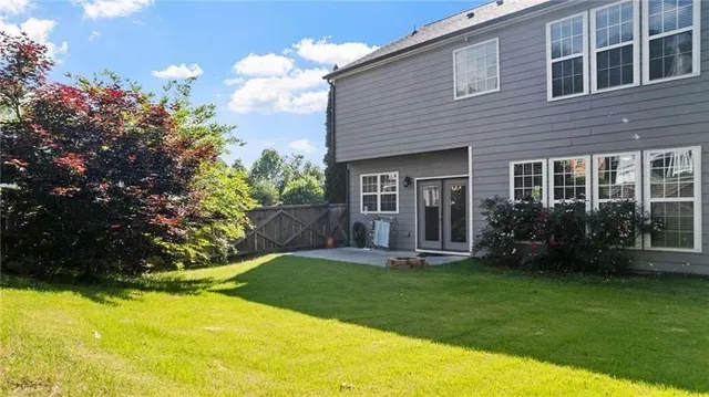 a view of a backyard with a garden and entertaining space