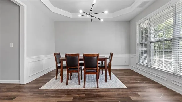 a view of a dining room with furniture and wooden floor