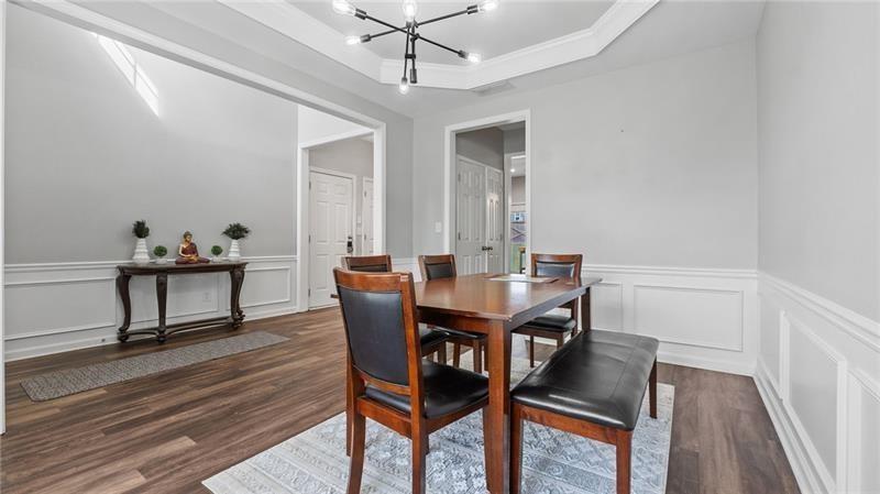 3525 Elder Field Lane Cumming, GA 30040 - Photo 6 of 45 a view of a dining room with furniture and wooden floor