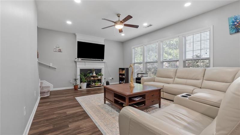 3525 Elder Field Lane Cumming, GA 30040 - Photo 8 of 45 a living room with furniture a fireplace and a flat screen tv