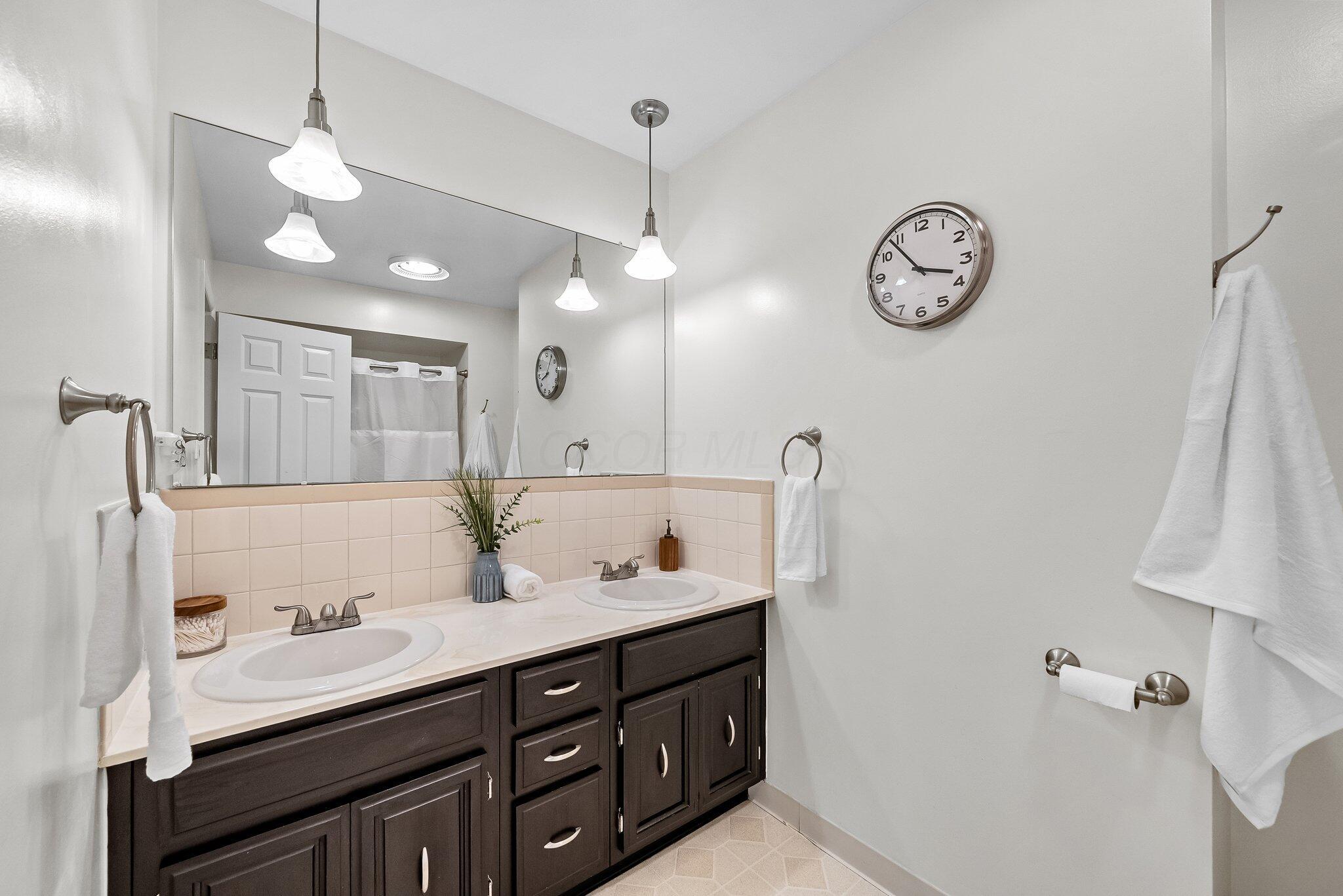 1269 Windham Road Columbus, OH 43220 - Photo 39 of 82 The hallway full bath has double vanities and a bathtub/shower.