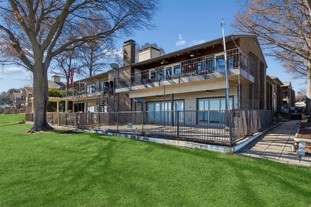 4548 Chaha Road, Unit 203 Garland, TX 75043 - Photo 17 of 18 a view of a house with a yard and deck