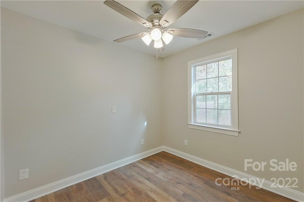 3804 Dusty Hollow Road Monroe, NC 28110 - Photo 12 of 42 an empty room with windows and ceiling fan