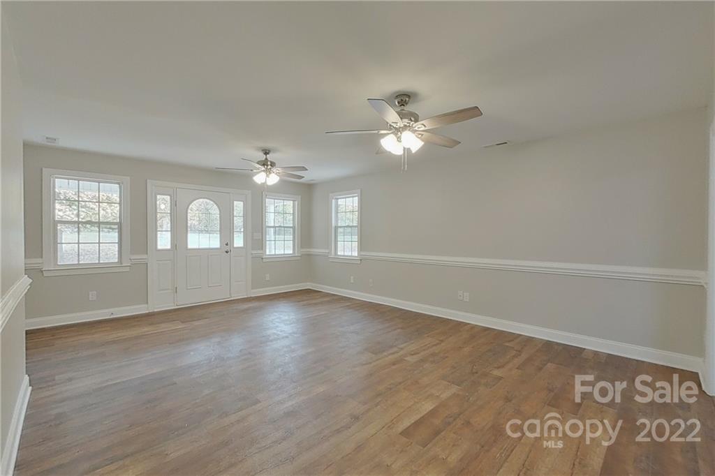 3804 Dusty Hollow Road Monroe, NC 28110 - Photo 13 of 42 wooden floor in an empty room with a window