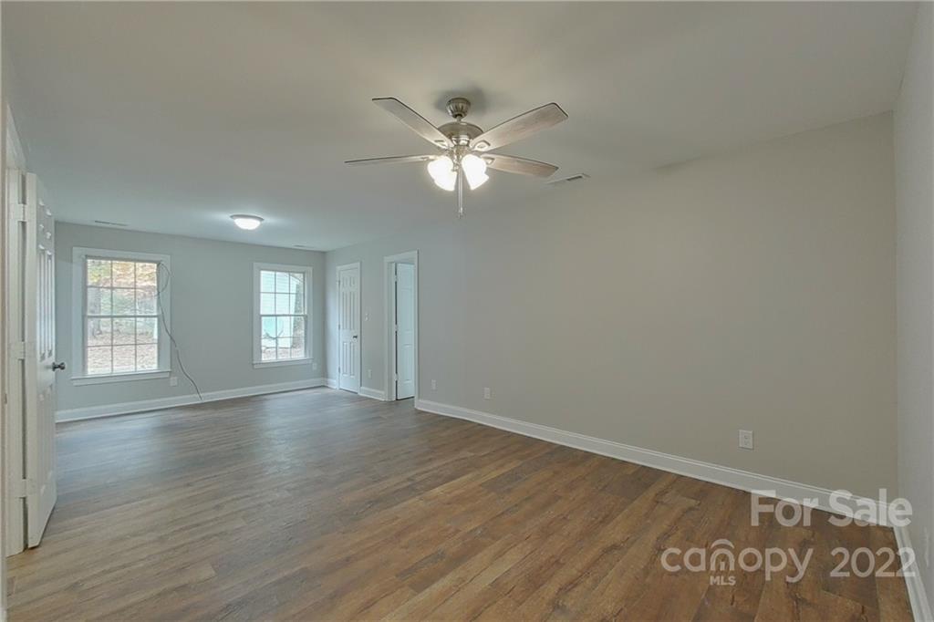 3804 Dusty Hollow Road Monroe, NC 28110 - Photo 14 of 42 a view of an empty room with window and wooden floor