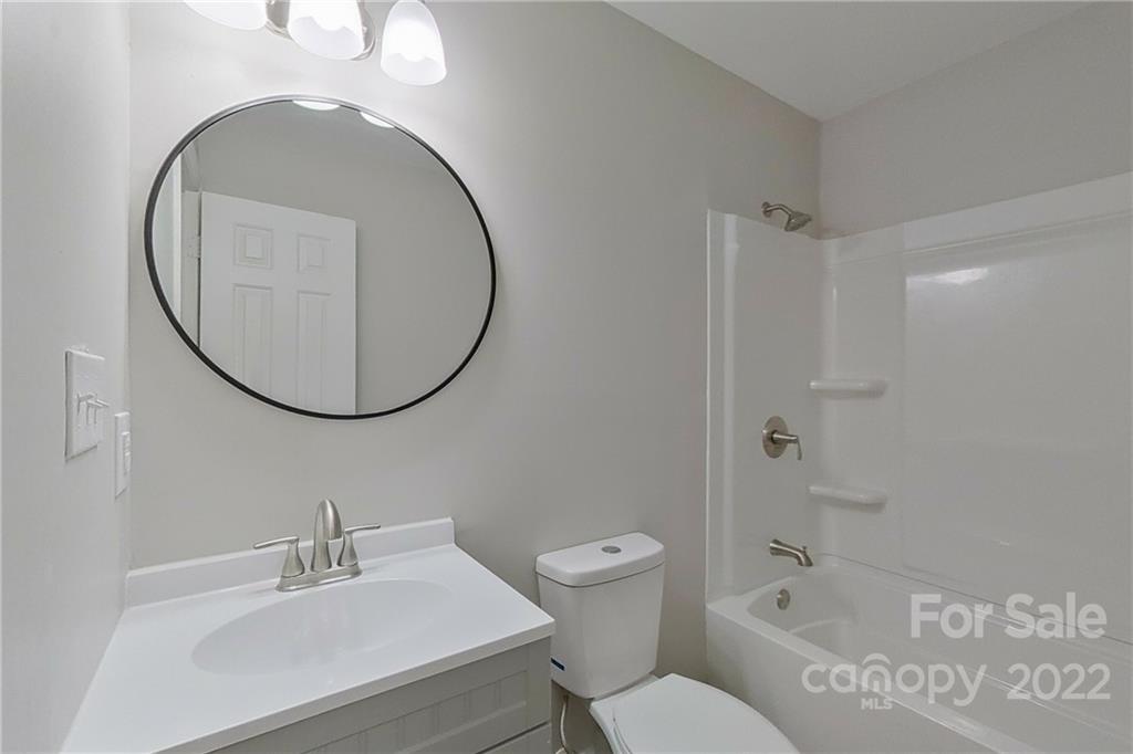 3804 Dusty Hollow Road Monroe, NC 28110 - Photo 15 of 42 a bathroom with a sink a toilet and a mirror