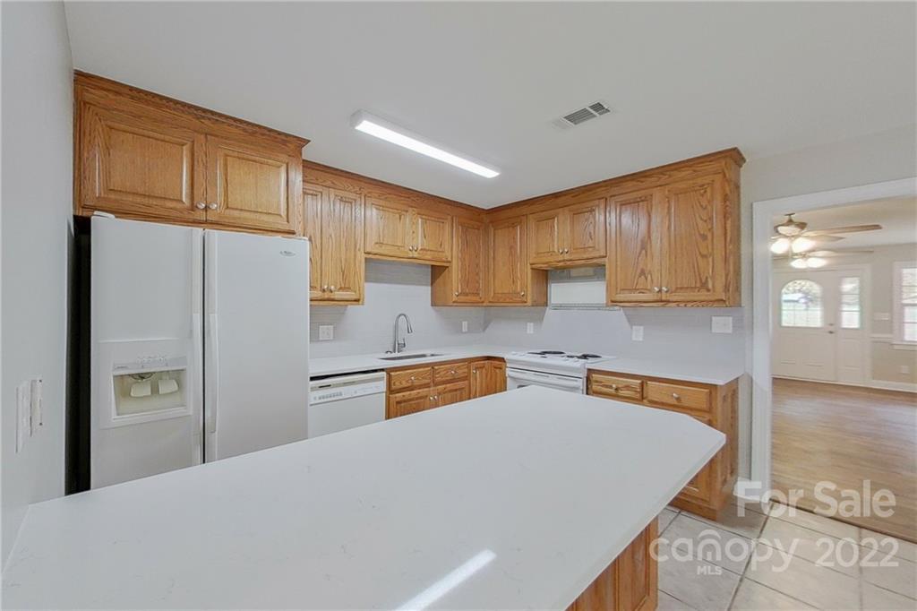 3804 Dusty Hollow Road Monroe, NC 28110 - Photo 23 of 42 a kitchen with stainless steel appliances granite countertop a refrigerator sink stove and microwave