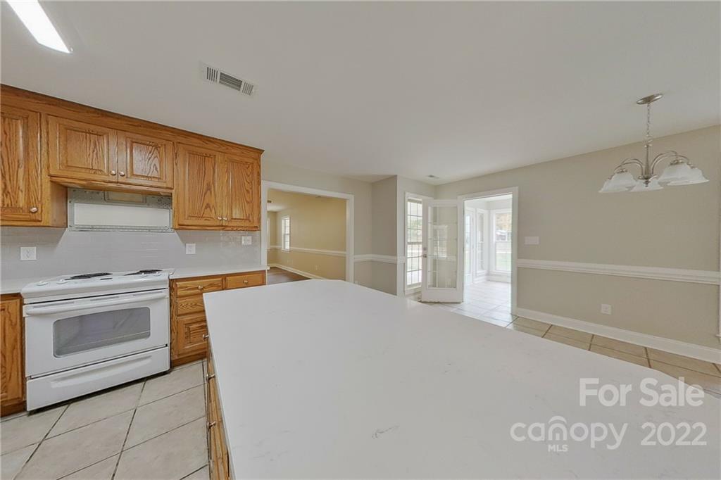 3804 Dusty Hollow Road Monroe, NC 28110 - Photo 24 of 42 a large kitchen with kitchen island granite countertop a stove a sink and a granite counter tops