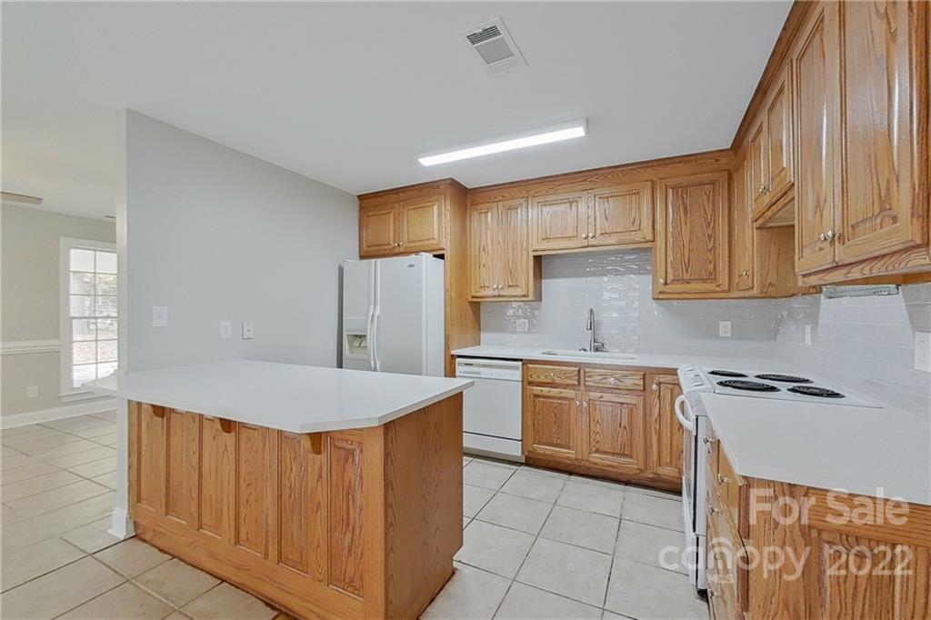 3804 Dusty Hollow Road Monroe, NC 28110 - Photo 25 of 42 a kitchen with a sink a stove a refrigerator and cabinets