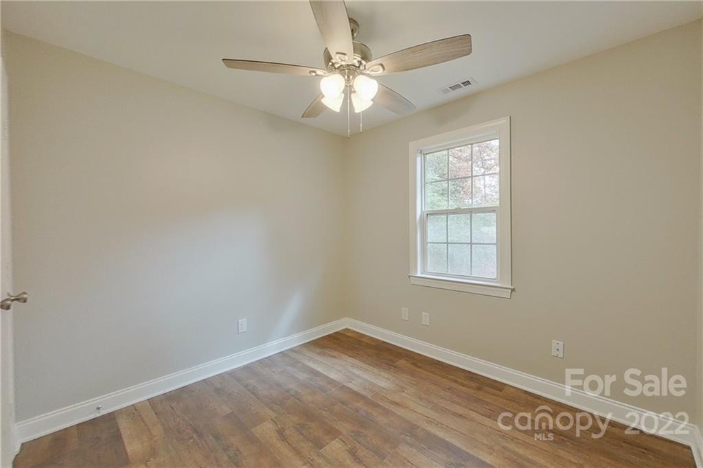 3804 Dusty Hollow Road Monroe, NC 28110 - Photo 31 of 42 an empty room with wooden floor and windows