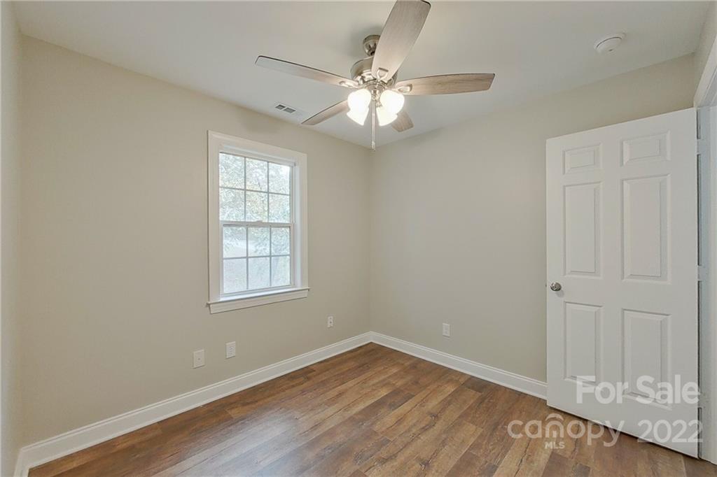 3804 Dusty Hollow Road Monroe, NC 28110 - Photo 33 of 42 a view of an empty room with wooden floor and a window