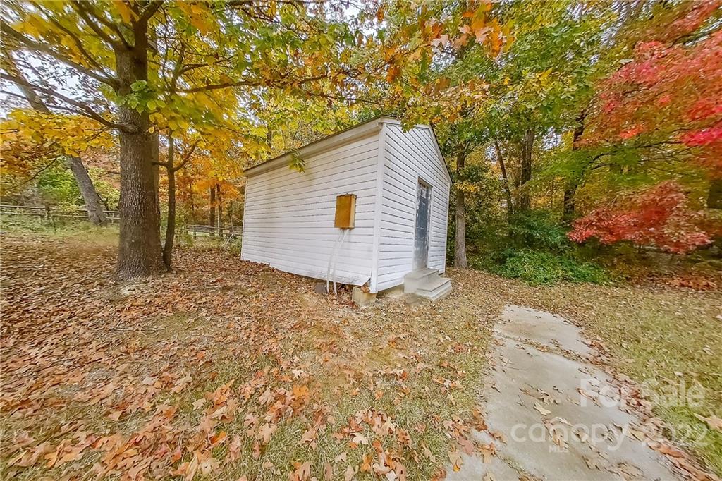 3804 Dusty Hollow Road Monroe, NC 28110 - Photo 42 of 42 a backyard of a house with large trees and wooden fence