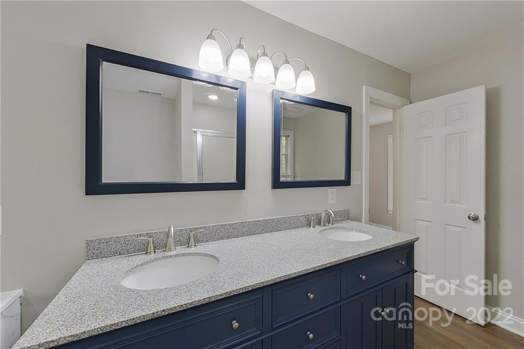 3804 Dusty Hollow Road Monroe, NC 28110 - Photo 7 of 42 a bathroom with double vanity sinks and a mirror