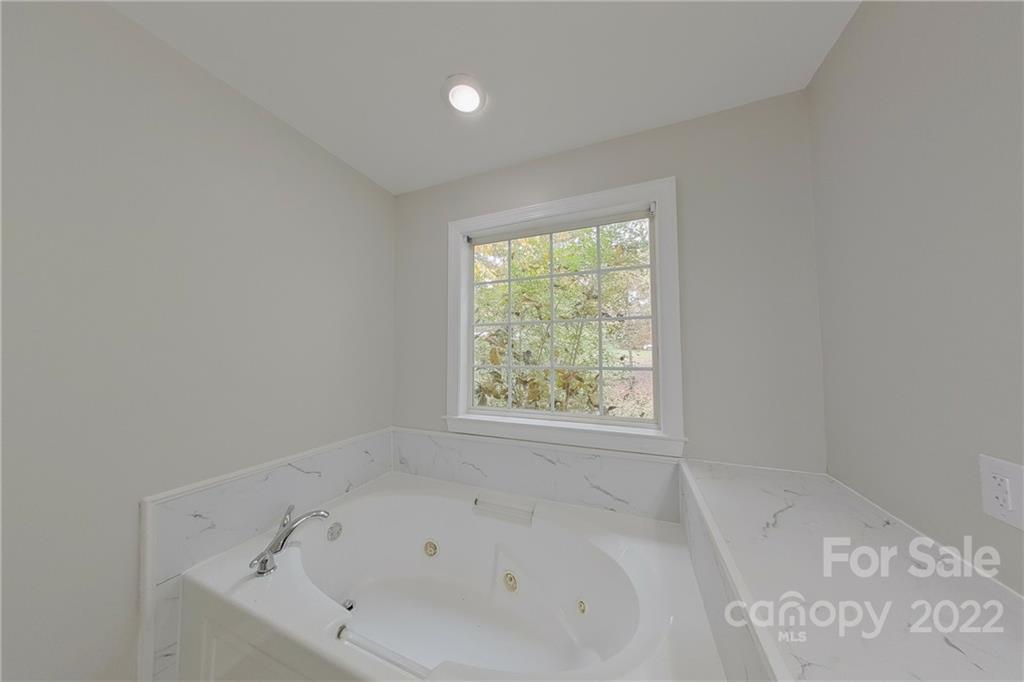 3804 Dusty Hollow Road Monroe, NC 28110 - Photo 9 of 42 a white bath tub sitting in a bathroom