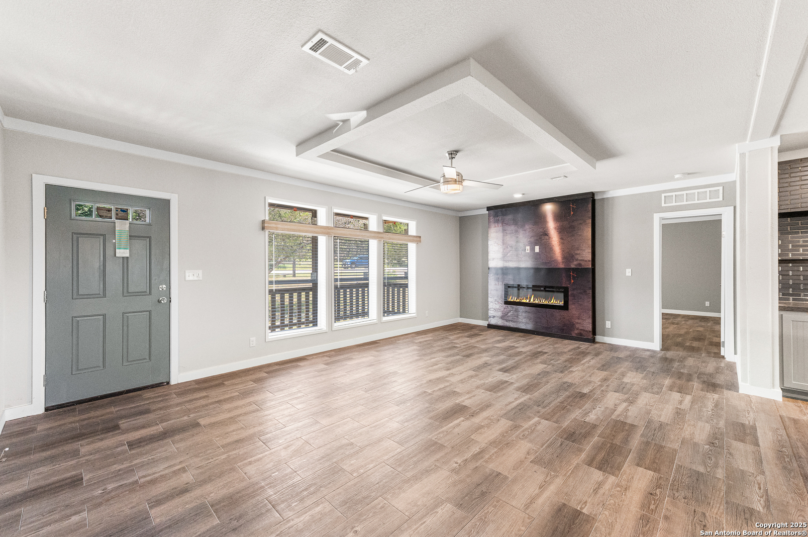 9130 Rebecca Creek Road Spring Branch, TX 78070 - Photo 11 of 77 a view of an empty room with wooden floor and a window