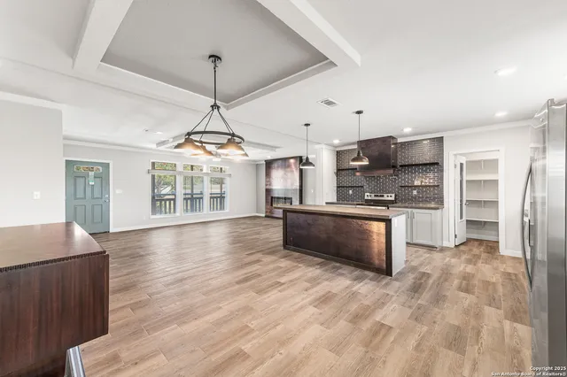 a bathroom with a granite countertop sink a large mirror and a bathtub