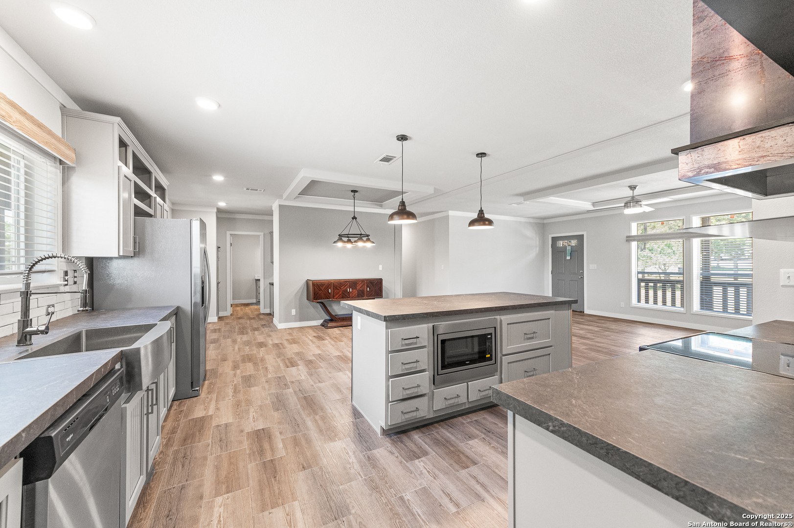 9130 Rebecca Creek Road Spring Branch, TX 78070 - Photo 14 of 77 a kitchen with stainless steel appliances granite countertop a sink a stove and a wooden floors