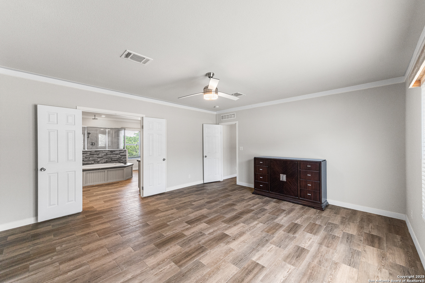 9130 Rebecca Creek Road Spring Branch, TX 78070 - Photo 19 of 77 a view of a livingroom with wooden floor and a ceiling fan