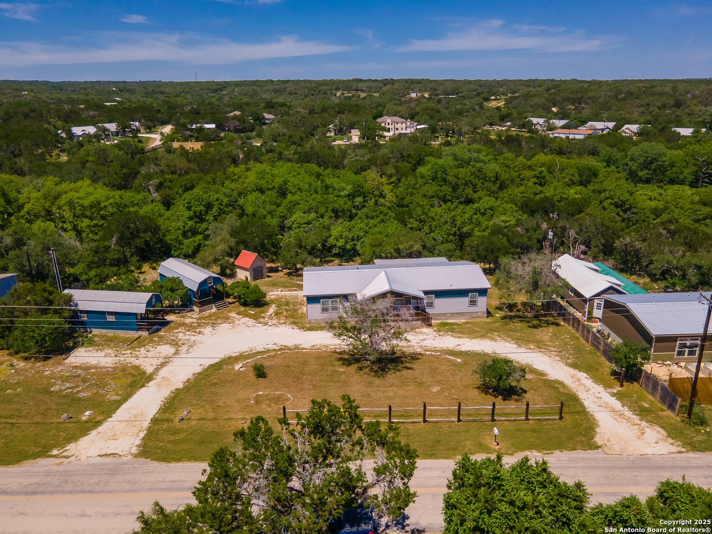 9130 Rebecca Creek Road Spring Branch, TX 78070 - Photo 2 of 77 an aerial view of residential houses with outdoor space