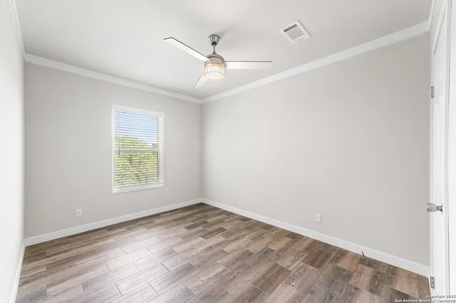 a view of a room with wooden floor