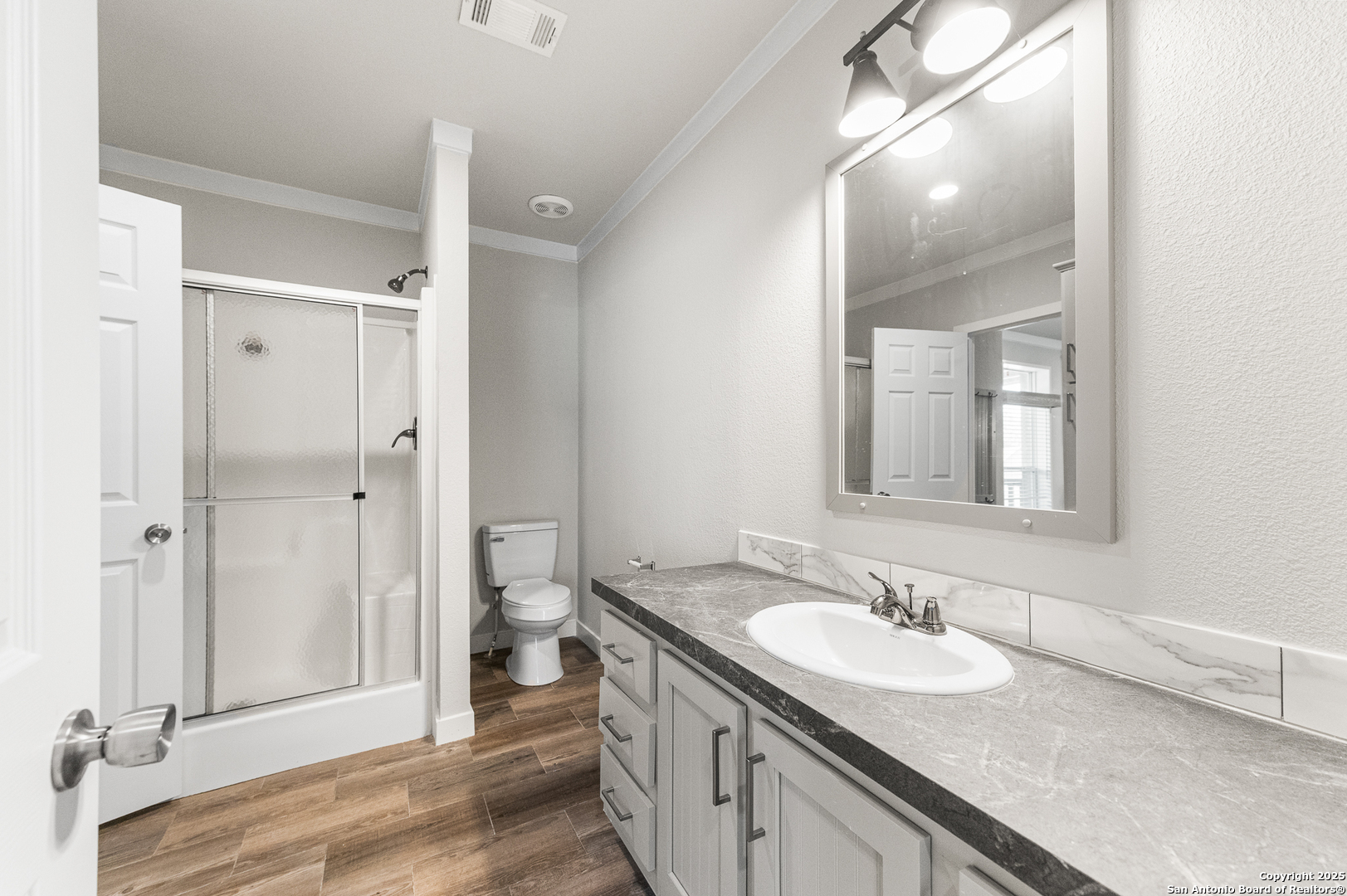 9130 Rebecca Creek Road Spring Branch, TX 78070 - Photo 28 of 77 a bathroom with a granite countertop sink and a mirror