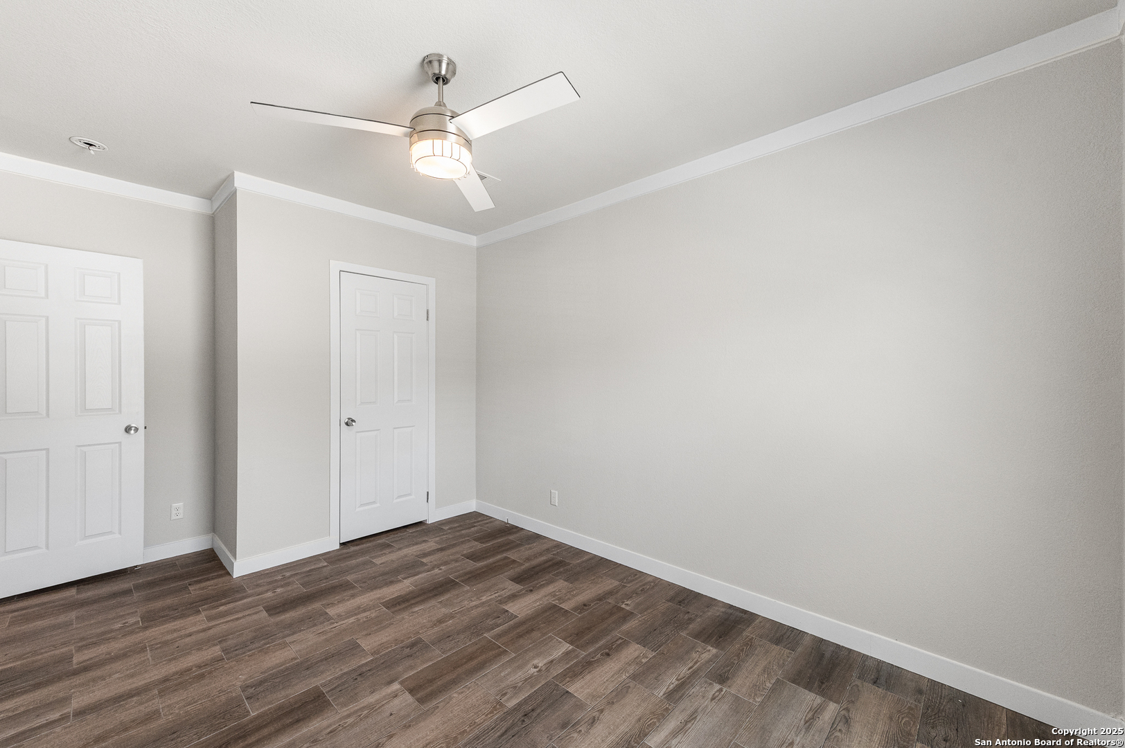 9130 Rebecca Creek Road Spring Branch, TX 78070 - Photo 32 of 77 a view of a room with wooden floor and a ceiling fan