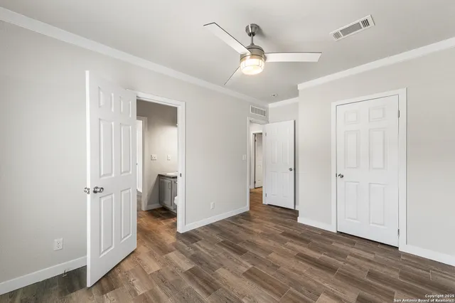 a bathroom with a toilet a sink a mirror and vanity